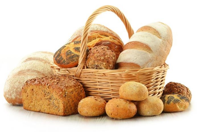 11844544 - composition with bread and rolls in wicker basket isolated on white